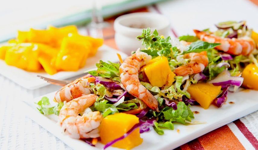 prawn salad with fresh mango fruit on tray